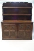 A Victorian oak dresser with extensive carved decoration representing mythical beasts,