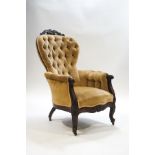 An Edwardian rosewood button back armchair, carved foliate scroll crest rail,