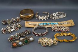 A selection of jewellery to include a rolled gold engraved bangle and eleven paste set costume