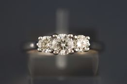 A white metal three stone diamond ring. Estimated total weight of 1.00 carats.