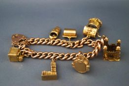 A rose gold curb link bracelet with seven assorted yellow gold heavy weight charms.