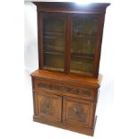 A Victorian mahogany secretaire bookcase, the glazed upper half with two adjustable shelves,