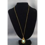 A yellow metal pendant set with a natural turquoise cabochon. Tests indicate 18ct gold.