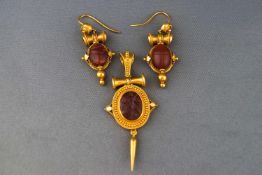 An Etruscan style pendant and matching pair of earrings, both set with carved agate.