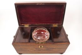 A 19th century rosewood tea caddy of sarcophagus form with ring handles,
