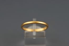 A 22 carat gold D shaped wedding ring,1.08 wide, hallmarks worn, size T, 3.
