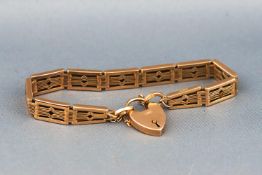 A hallmarked 9 carat gold gate style bracelet with padlock and safety chain. 17.