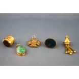 A selection of gold charms to include a bloodstone seal (uncarved), a Maltese cross, a gold tassel,