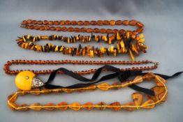 A quantity of amber and imitation-amber necklaces; comprising; an opaque,