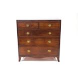 A George IV mahogany chest of two short and three long drawers with brass ring handles,