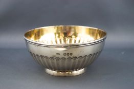 A silver sugar bowl by George Adams, the round body part fluted on a short slightly flared foot,