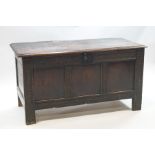 A 17th century oak coffer with interior candle box, iron lock and butterfly hinges to lid,