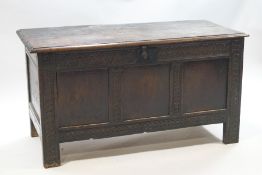 A 17th century oak coffer with interior candle box, iron lock and butterfly hinges to lid,