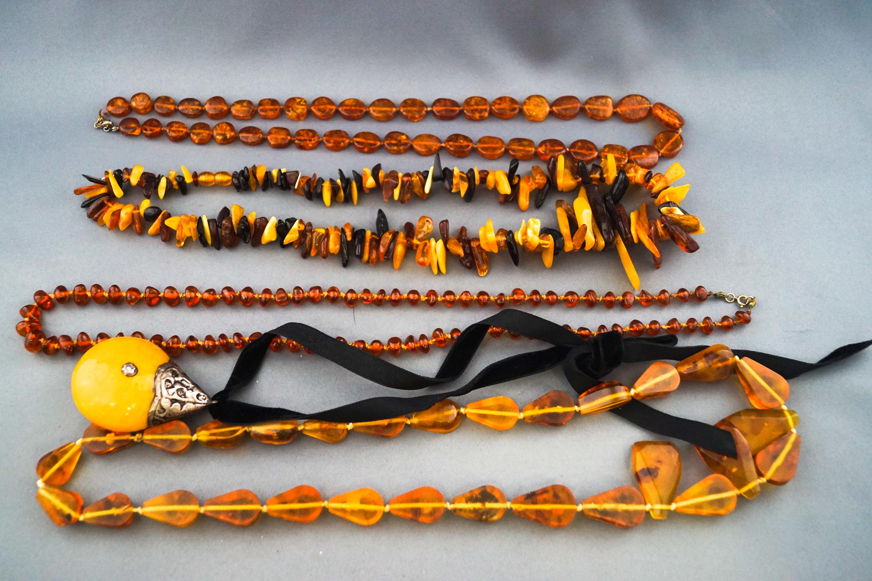 A quantity of amber and imitation-amber necklaces; comprising; an opaque, - Image 2 of 2