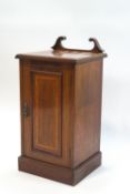 An Edwardian mahogany pot cupboard with broken swan neck back, satinwood cross banded top and door,
