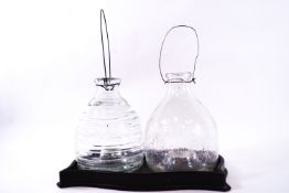 Two Victorian glass wasp/fly catchers, one modelled as a beehive, the other with insects, 20cm high,