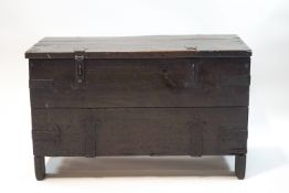 A 17th century style wrought iron bound oak chest with hinged cover,