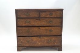 A George III oak chest of two short over three drawers,