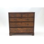 A George III oak chest of two short over three drawers,