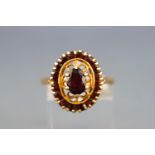 A yellow metal garnet cluster ring, Hallmarked 9ct gold, London, 1978. Size; P 3.