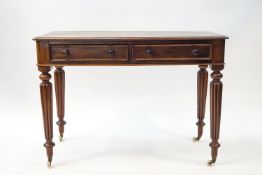 A 19th century mahogany two drawer side table on gadrooned legs and ceramic casters,