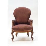 A Victorian mahogany nursing chair with foliate scroll arms,