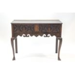 A 17th century style oak two drawer side table, the drawers with inlay and geometric carving,