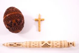 A Victorian coquilla nut pomander in the shape of an egg, containing a crucifix,