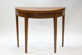 A George III mahogany demi-lune card table with boxwood stringing and square tapering legs, 73.