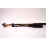 A ladies walking cane with engraved gilt metal mounts and decorative ball knop