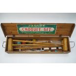 A Jacques croquet set with four mallets, four balls and metal hoops,