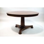 A William IV mahogany tilt top breakfast table on inverted octagonal column and triform base,