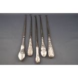 Five silver handled button hooks, comprising; a plain example with a shaped wavy handle,