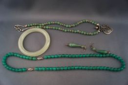 Five green hardstone jewels,