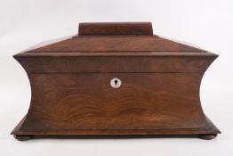 An early Victorian rosewood tea caddy of sarcophagus form with two lidded compartments and later