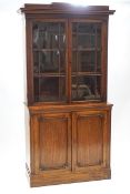 A 19th century mahogany glazed bookcase with cupboard base,
