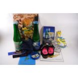 A collection of Babycham memorabilia including slippers, money bank bottles,