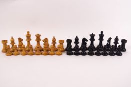 A turned wood chess set, natural and ebonised, in a wooden box, the lid stamped 'Best London Make',