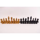 A turned wood chess set, natural and ebonised, in a wooden box, the lid stamped 'Best London Make',