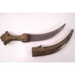 An Indian dagger with curved blade engraved with foliage in low relief,