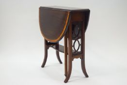 An Edwardian crossbanded mahogany Sutherland table with pierced ends,