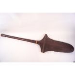 A Polynesian wooden paddle with partially serrated sides,