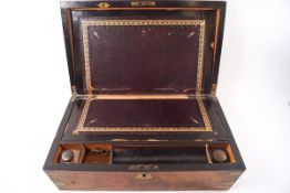 A Victorian burr walnut brass bound writing slope with purple leather inset surface and two glass