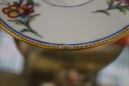 A Sevres chocolate cup, cover and trembleuse saucer, painted with flower sprays,
