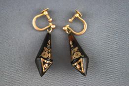 A pair of Victorian earrings stylized as a kite shaped horn inlaid with delicate gold design.