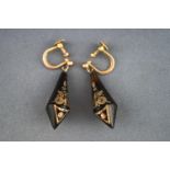 A pair of Victorian earrings stylized as a kite shaped horn inlaid with delicate gold design.