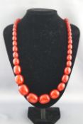 A single strand of graduated cherry amber beads. Strung plain with screw clasp. 109.