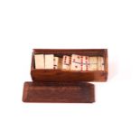 A 19th Century miniature bone set of dominoes within wooden box, 5.