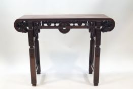 A 20th century Chinese hardwood alter table with scroll ends and carved detail, 84.