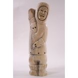 An Inuit carved bone figure of an Eskimo, height 27cm.